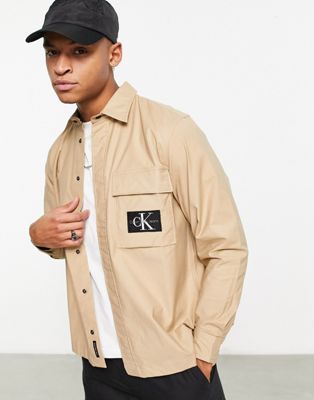 Calvin Klein Jeans badge logo long sleeve shirt in beige - ASOS Price Checker