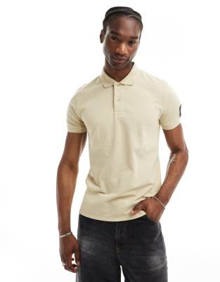 Calvin Klein Jeans badge polo shirt in beigeNeutral