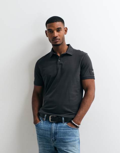Calvin Klein Jeans badge polo shirt in black - view 1