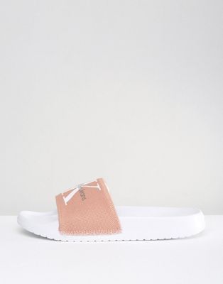 pink and white calvin klein sliders