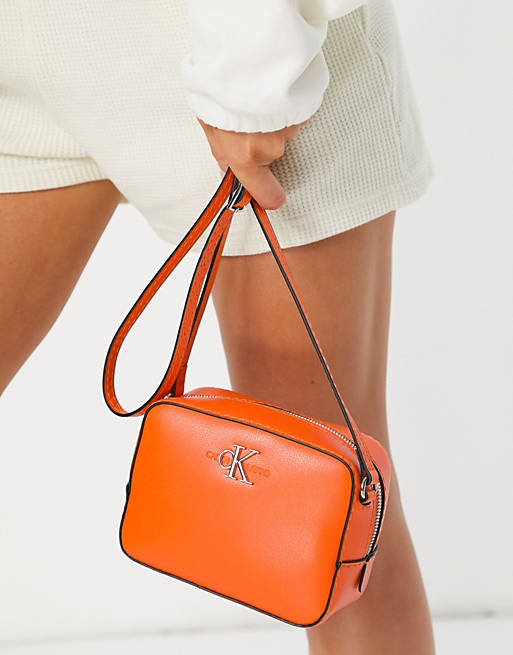 Calvin Klein Jeans CK logo camera bag in orange | ASOS