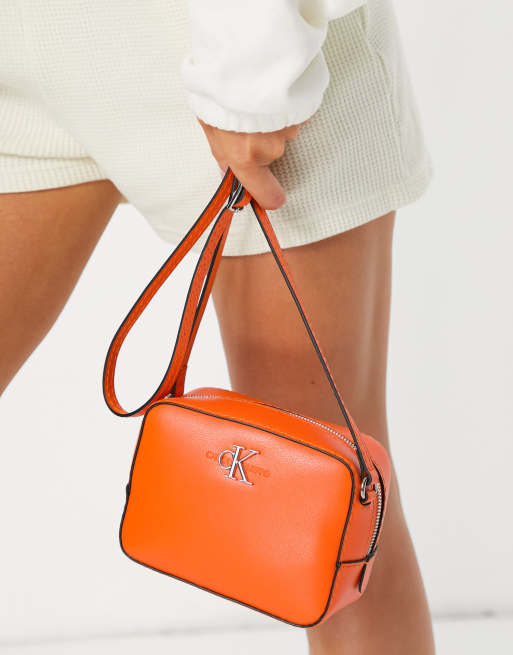 Calvin Klein Jeans CK logo camera bag in orange