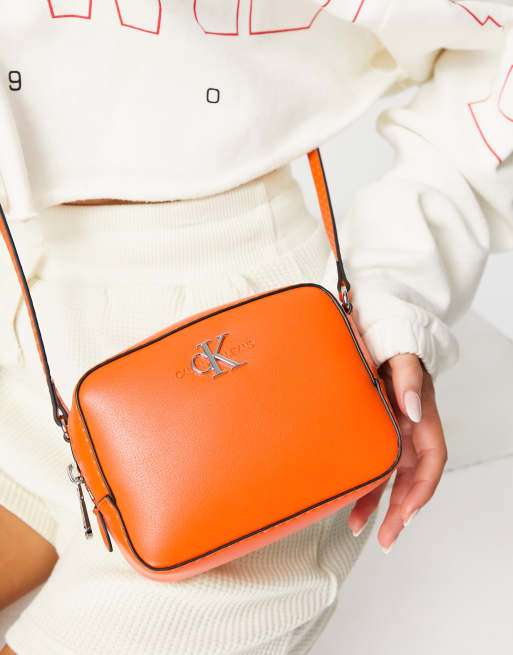 Calvin Klein Jeans CK logo camera bag in orange