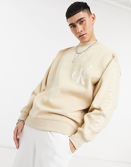 Calvin Klein Jeans contrast logo mock neck eco sweatshirt in beige | ASOS