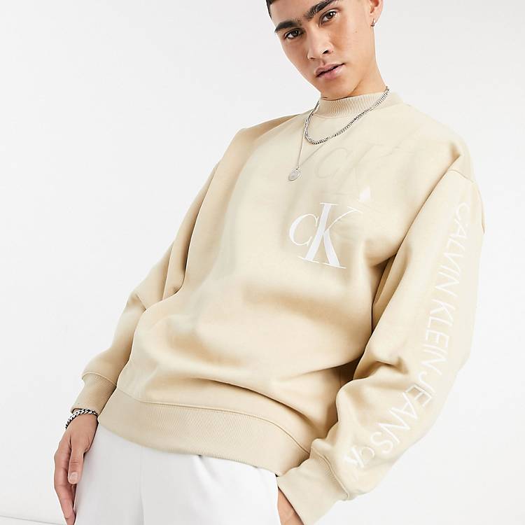 Calvin Klein Jeans contrast logo mock neck eco sweatshirt in beige | ASOS