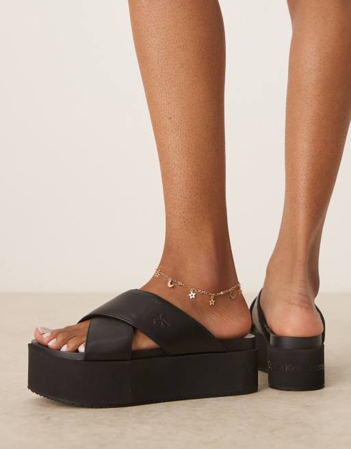 Calvin Klein Jeans cross strap flatform sandals in black
