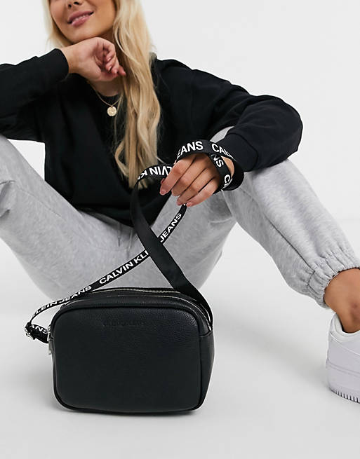 Calvin Klein Jeans crossover bag with logo taping strap in black | ASOS