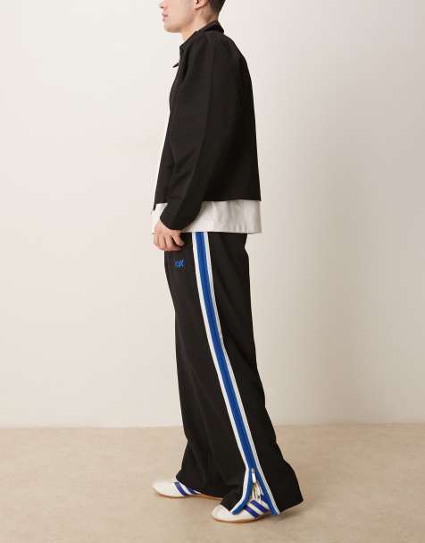 Calvin Klein Jeans stripe track pants in black and blue
