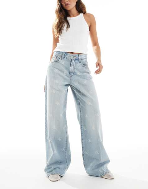 Calvin Klein Jeans distressed logo print wide leg jeans in light wash - view 1