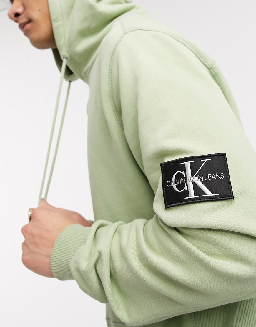 Calvin Klein Jeans – Grön huvtröja i cargostil med monogramlogga