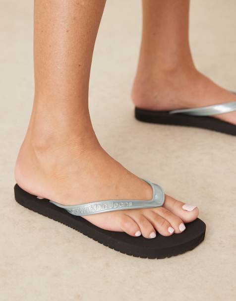 Calvin Klein Jeans logo flip flops in black and light blue - view 1