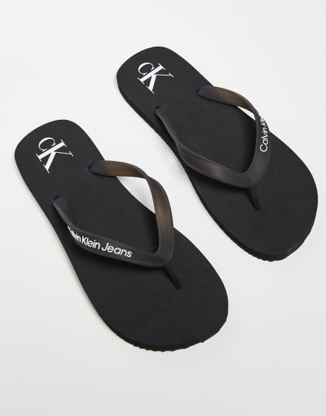 Calvin Klein Jeans logo flip flops in black - view 1