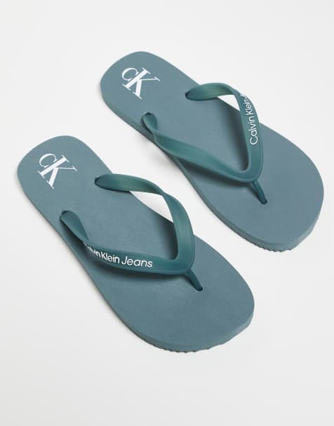 Calvin Klein Jeans logo flip flops in blue - view 1
