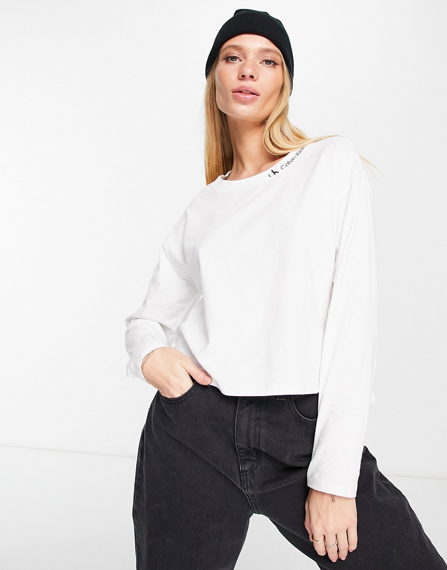 Calvin Klein Jeans logo long sleeve high low hem top in white