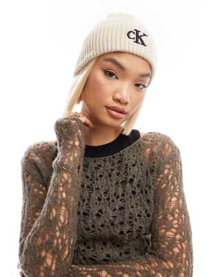 Calvin Klein Jeans Calvin Klein Jeans logo pom pom beanie in cream-White