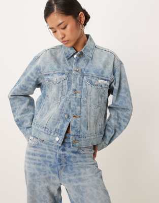 Calvin Klein Jeans logo print denim trucker jacket in lightwash blue