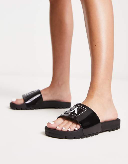 Calvin Klein Jeans logo rubber sliders in black ASOS