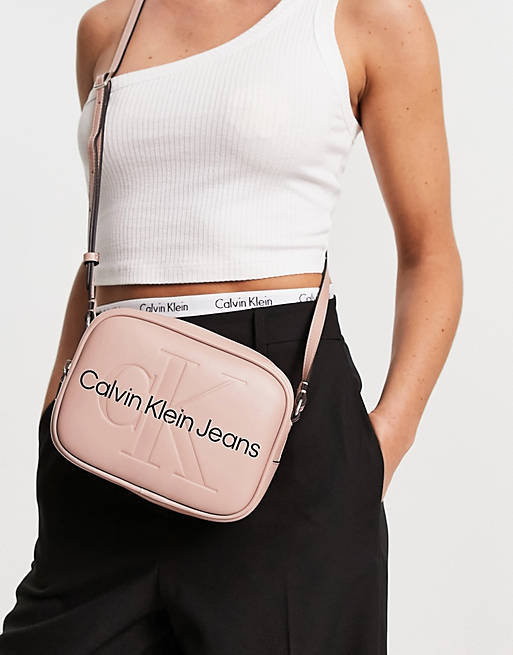Calvin Klein Jeans logo sculpted cross body camera bag in pink | ASOS
