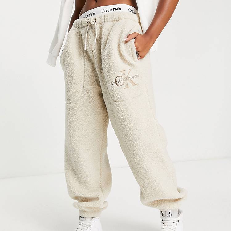 Calvin Klein Jeans logo sherpa joggers in eggshell | ASOS
