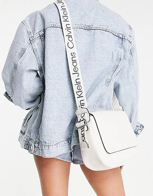 Calvin Klein Jeans logo strap crossbody bag in ecru | ASOS