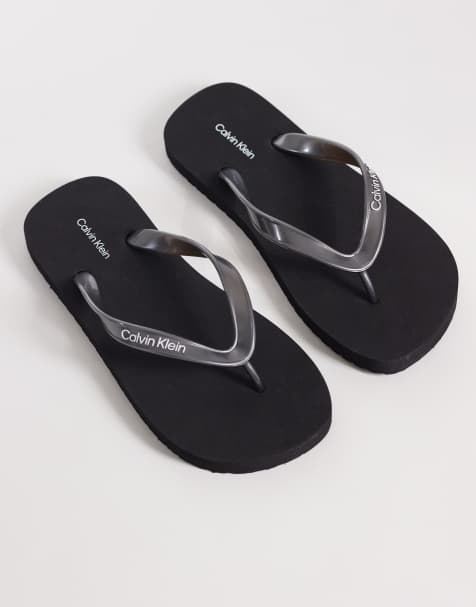 Calvin Klein Jeans metallic flip flops in black - view 1