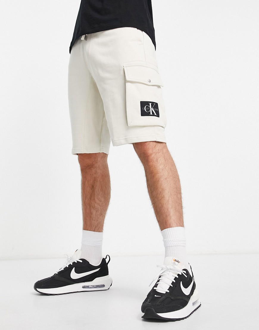 Calvin Klein Jeans monogram badge sweat shorts in stone-White