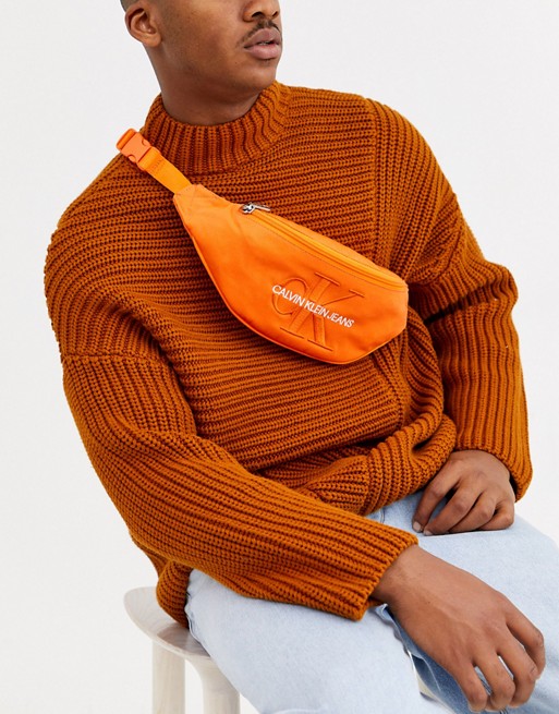 Calvin Klein Jeans monogram bum bag in orange
