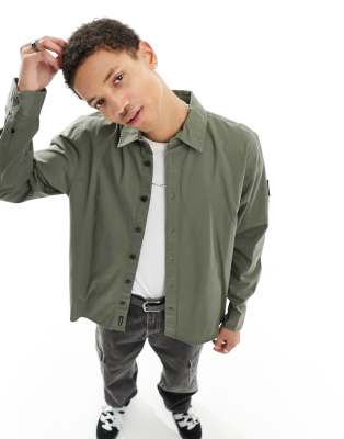 Calvin Klein Jeans monogram logo badge relaxed shirt in olive - ASOS Price Checker