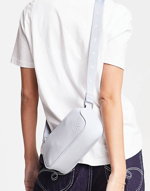 Calvin Klein Jeans monogram logo strap double zip camera bag in light blue  | ASOS