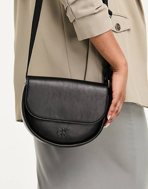 Calvin Klein Jeans monogram logo strap saddle bag in black | ASOS
