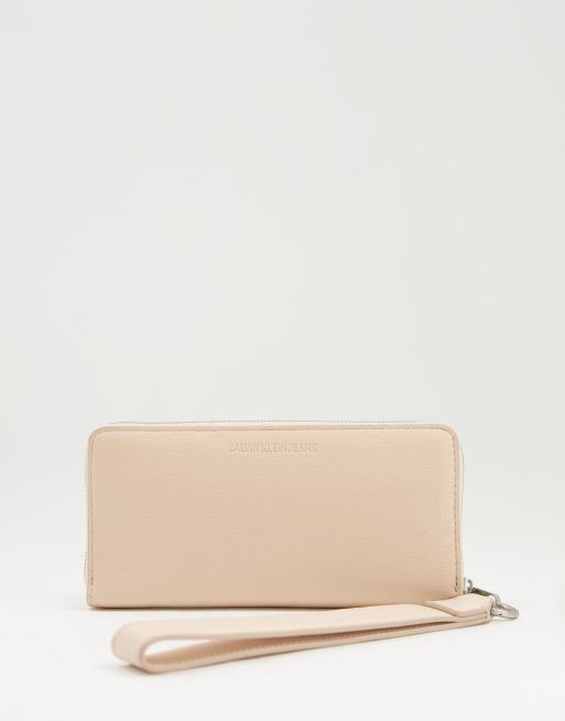 Calvin Klein Jeans monogram logo wristlet purse in cream