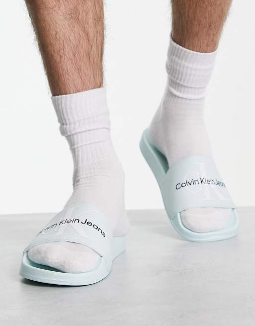 Calvin Klein Jeans monogram sliders in light blue ASOS