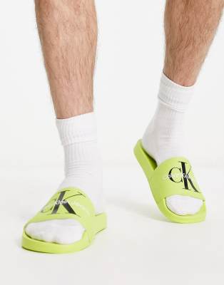 Calvin Klein Jeans monogram sliders in yellow | ASOS