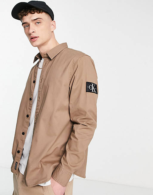 Calvin Klein Jeans monologo badge relaxed fit overshirt in tan | ASOS