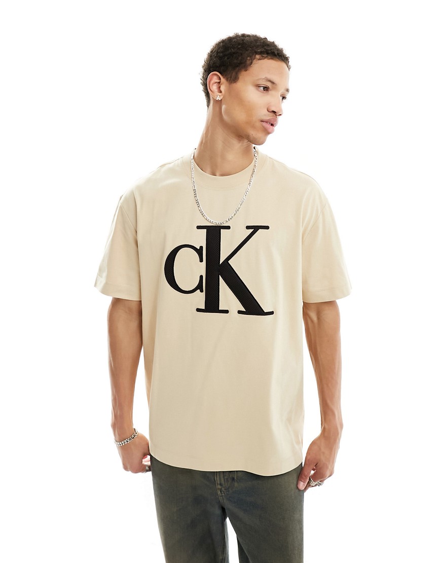 Calvin Klein Jeans perforated monogram logo t-shirt in sand-Neutral
