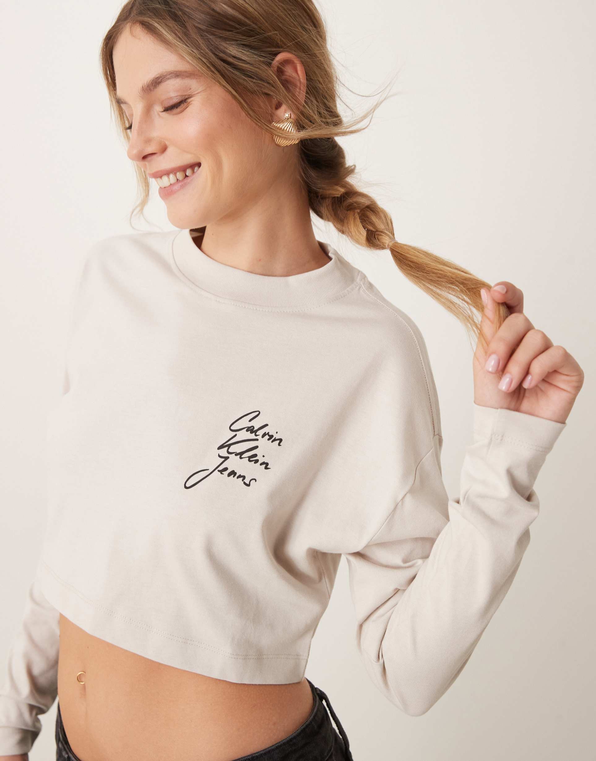 calvin klein jeans script logo crop long sleeve t-shirt in beige