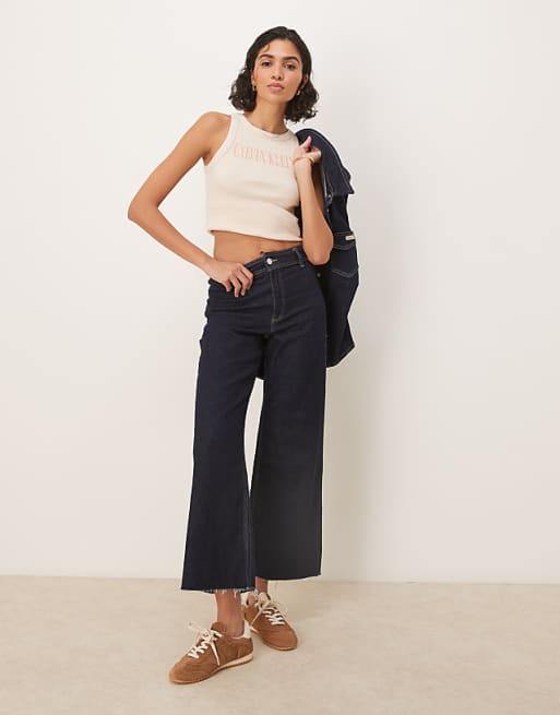 Calvin Klein Jeans script logo rib tank top in beige | ASOS Calvin Klein Jeans script logo rib tank top in beige | ASOS