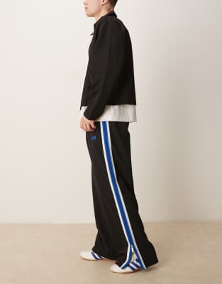 Calvin Klein Jeans Calvin Klein Jeans stripe track pants in black and blue