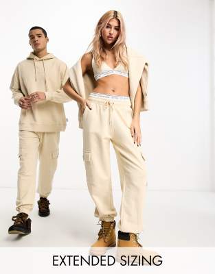 Calvin Klein Jeans unisex cargo joggers in beige - exclusive to ASOS-Neutral