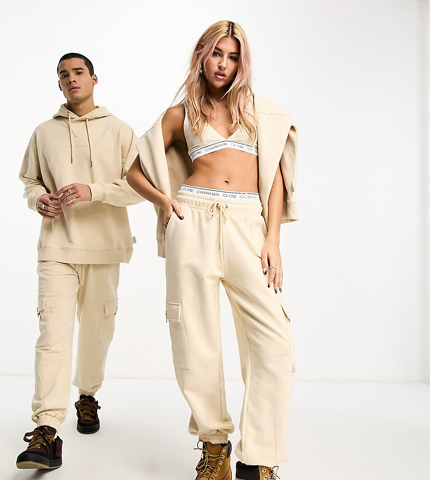 Calvin Klein Jeans unisex cargo sweatpants in beige - exclusive to ASOS-Neutral