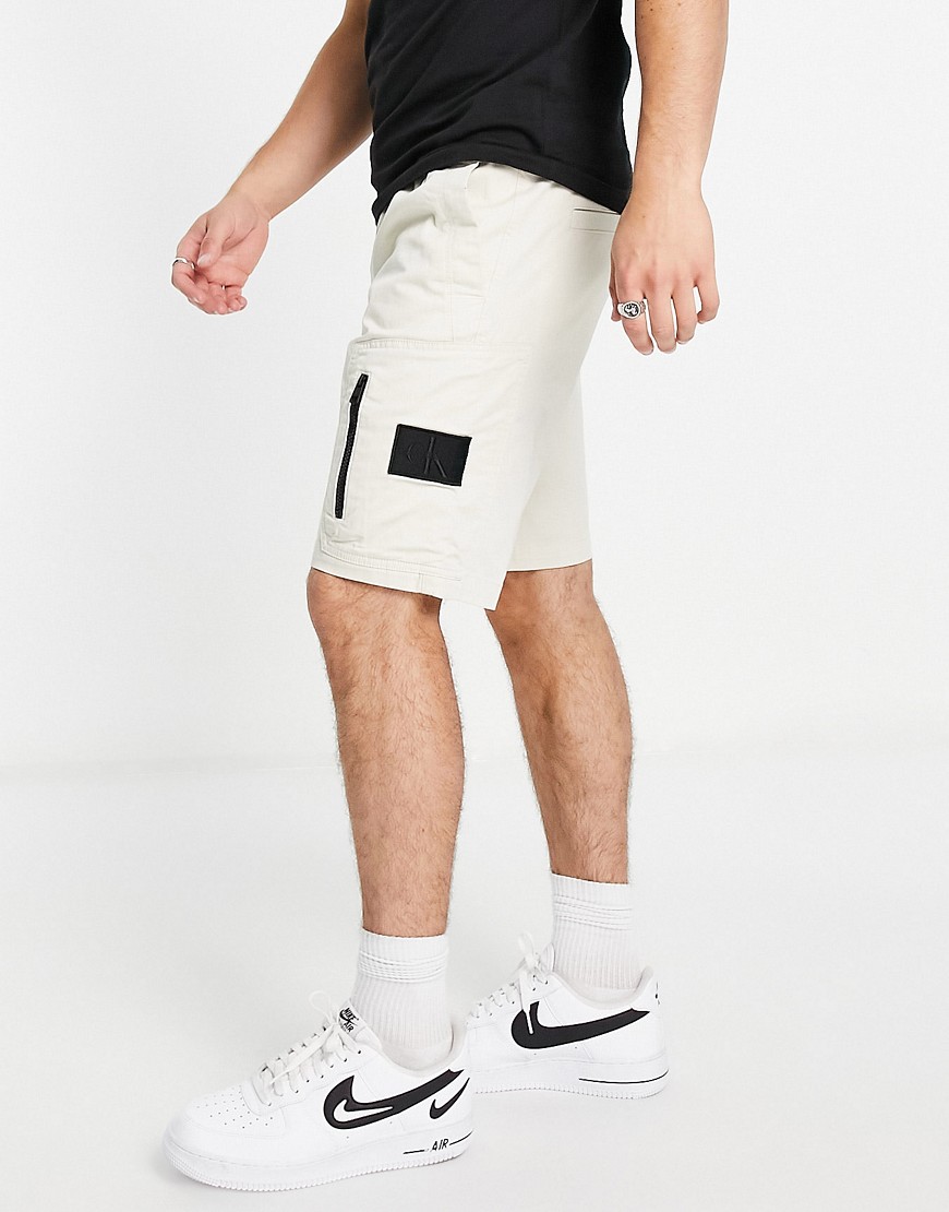 Calvin Klein Jeans washed cargo shorts with zip detail in stone-Neutral