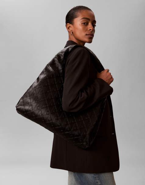 Calvin Klein logo embossed large shoulder purse in black - view 1