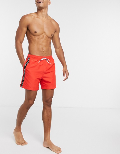 Calvin Klein logo tape swim shorts in red
