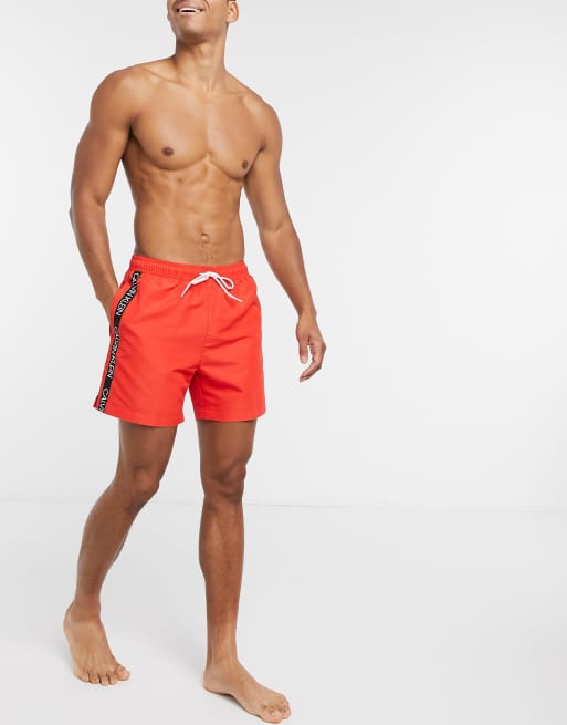 Calvin Klein logo tape swim shorts in red | ASOS