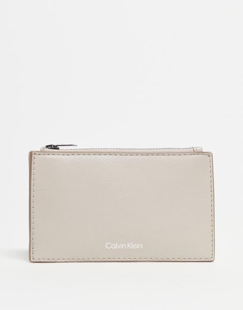 Calvin Klein logo zip purse in beige - view 1