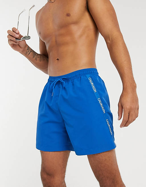 totaal Vijftig Geliefde Calvin Klein medium length swim shorts in blue | FaoswalimShops