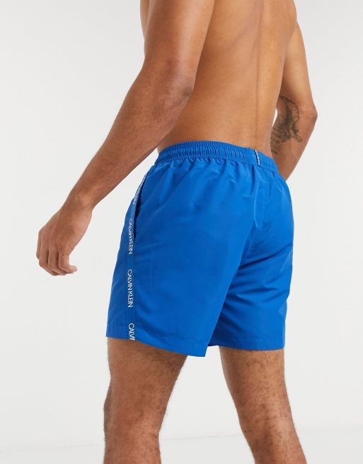 Calvin Klein medium length swim trunks in blue