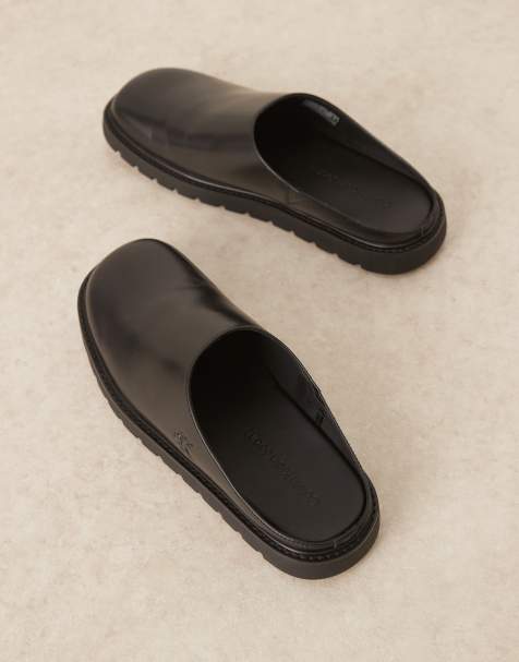 Calvin Klein molded slip on mules in black - view 1