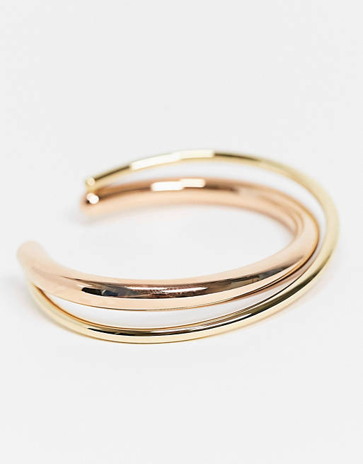Calvin Klein open double cross over bangle in gold and rose gold | ASOS