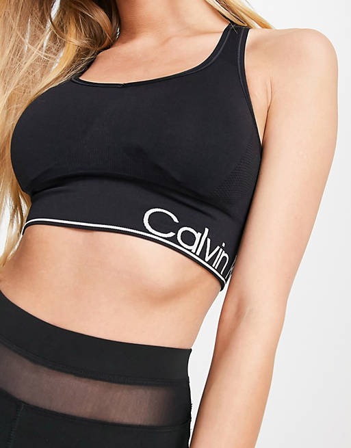 Calvin Klein Performance medium impact v-neck racerback seamless sports bra  with removable cups in black | ASOS